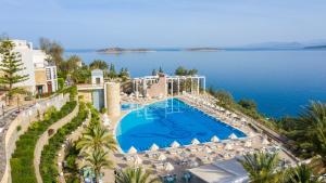 an aerial view of a resort with a swimming pool and the ocean at Duja Bodrum in Torba