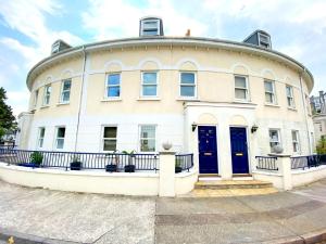 a large white building with a round top at Lisburne Place - Luxury Three Bedroom Town House in Torquay