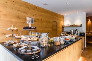 a counter with a bunch of pastries on display at JOAS natur.hotel.b&b in San Candido