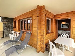 a room with chairs and tables in a cabin at Apartment Jacky 7 in Verbier