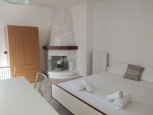 a bedroom with a bed and a fireplace at Dony's holiday homes CISE 15782 in Pontinia