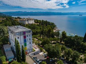 an aerial view of a building next to a body of water at Hostel Link in Lovran