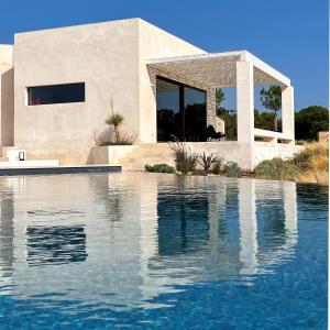a house with a swimming pool in front of a house at Villa CREA in Marina di Leuca