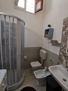 a bathroom with a shower and a toilet and a sink at Tra mare e profumi in Trapani