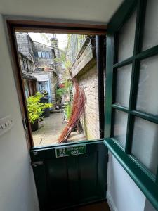 an open window with a view of a street outside at The Well House Boutique Cottage Hebden Bridge Central in Hebden Bridge