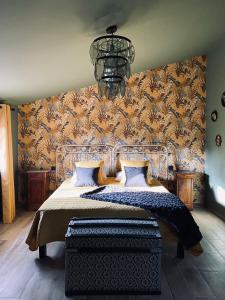 a bedroom with a large bed and a chandelier at Sous Les Pins gîtes et chambres d'hôtes in La Londe-les-Maures +37 photos