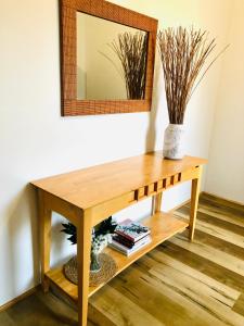 a wooden table with a mirror on a wall at Mandurah Waterfront Retreat in Mandurah