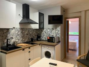 a kitchen with a washing machine and a washer at Home SEA&DREAMS Beach in Calpe