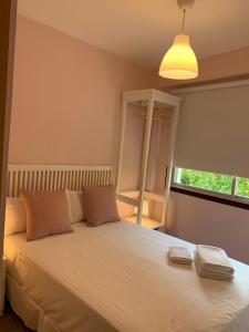 a bedroom with a large white bed with a window at Home SEA&DREAMS Beach in Calpe