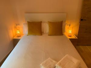 a bedroom with a bed with two lights on it at Home SEA&DREAMS Beach in Calpe +3 photos