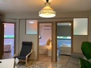 a living room with a chair and a bedroom at Home SEA&DREAMS Beach in Calpe