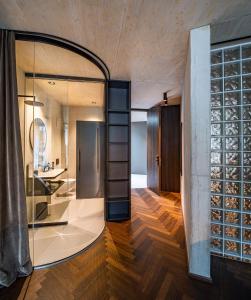 a room with a glass wall and a hallway with wood floors at Lifestyle B&B by Phillip Sigwart in Brixlegg