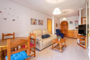 a living room with a couch and a table at IDEAL para VERANO con PISCINA e INVIERNO con COCINA de LEÑA in La Mata