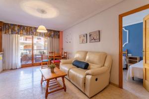 a living room with a couch and a table at IDEAL para VERANO con PISCINA e INVIERNO con COCINA de LEÑA in La Mata