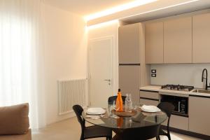a kitchen with a table and chairs in a room at Residence TRE LEONI in Caorle
