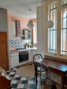 a kitchen with a wooden table and a dining room at Ventisette in Cremona