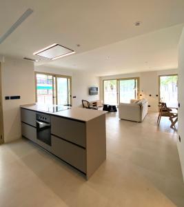 a large kitchen with an island in the middle at Acacias Suites Apartments Salou in Salou