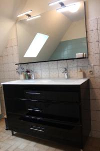 a bathroom with a sink and a large mirror at ROC callac in Saint-Gilles-du-Vieux-Marché