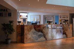a lobby with a large counter with a counter top at Hotel Opal in Jupiter +103 photos