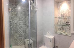 y baño con ducha y aseo. en Agréable appartement en Rabat