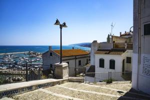 a street light on top of a building with a harbor at Terrazza Grecale in Rodi Garganico