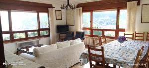 sala de estar con sofá blanco y mesa en CASA RURAL ABLANO CUDILLERO en PLAYA CONCHA ARTEDO, en Lamuño