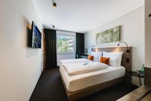Postel nebo postele na pokoji v ubytování NIGHT INN Hotel Bahnhofcity Feldkirch