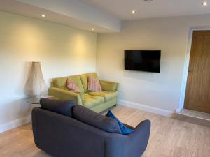 a living room with a couch and a chair at The Granary in Stirling