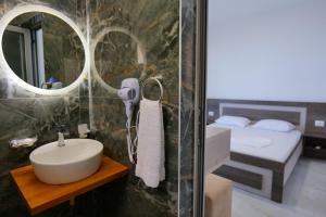 a bathroom with a sink and a mirror at Hotel Joni Lukove in Lukovë +29 photos
