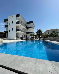 a large swimming pool in front of a building at Hotel Villa Ruci in Ksamil