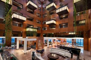 a lobby of a building with furniture and plants at Radisson Blu Hotel & Spa, Istanbul Tuzla in Istanbul