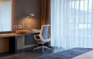 a room with a desk and a chair next to a window at Radisson Blu Hotel & Spa, Istanbul Tuzla in Istanbul
