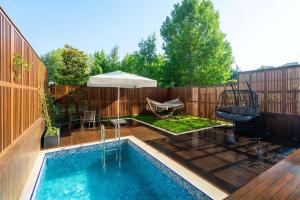 a small swimming pool in a backyard with a fence at Radisson Blu Hotel & Spa, Istanbul Tuzla in Istanbul