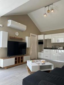 a living room with white cabinets and a flat screen tv at Lovely 1BR with Private Heated pool at El-Gouna in Hurghada