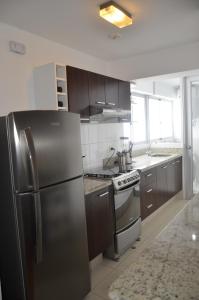 a kitchen with a stainless steel refrigerator and a stove at Miraflores Apartments in Lima
