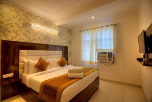 a bedroom with a large bed and a window at Ark of Avalon Near IGI AirPort New Delhi in New Delhi