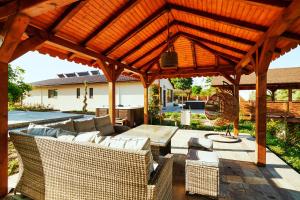 a wooden pavilion with a couch and a table at Casa Chilia Resort&Spa in Chilia Veche