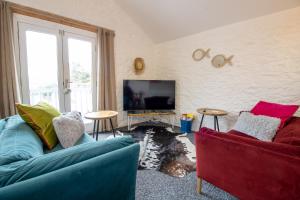 a living room with two couches and a tv at Cozy, Chic, Dairy Cottage near to Beach & Shops- Parking in Torquay