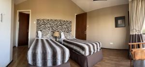 Postel nebo postele na pokoji v ubytování Nyikani House + 20 fotografií