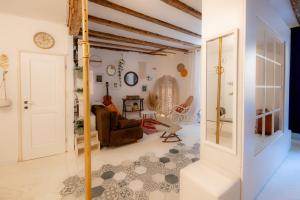 a living room with a couch and a chair at Rosalia Apartment in Koper