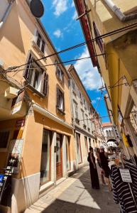 a group of people standing on a street with buildings at Rosalia Apartment in Koper