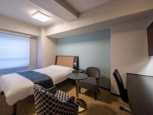 Een bed of bedden in een kamer bij APA Hotel Asakusabashi Ekimae