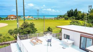a balcony of a house with a view of the ocean at Nabee no Yado B057 in Onna
