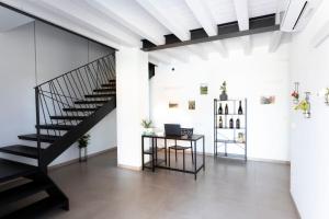 a black staircase in a white room with a desk at Agriturismo Tiare dal Gorc in Gorgo