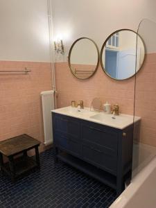 a bathroom with a sink and a mirror at La tour de Jade in Avallon +4 photos