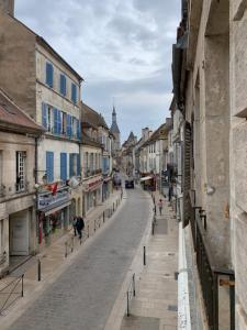 an empty street in a city with buildings at La tour de Jade in Avallon