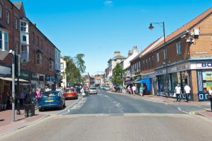 a city street with cars parked on the side of the road at Hidden Gem Cottage, Driffield in Great Driffield