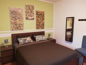 a bedroom with a bed and a blue chair at Case Vacanze Borgo Faraldi in Villa Faraldi