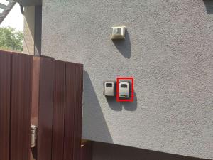 a red soap dispenser on the side of a building at Apartmán Lenka in Boršice