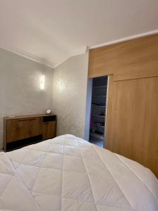 a bedroom with a large white bed and a closet at Budva house Maja in Budva